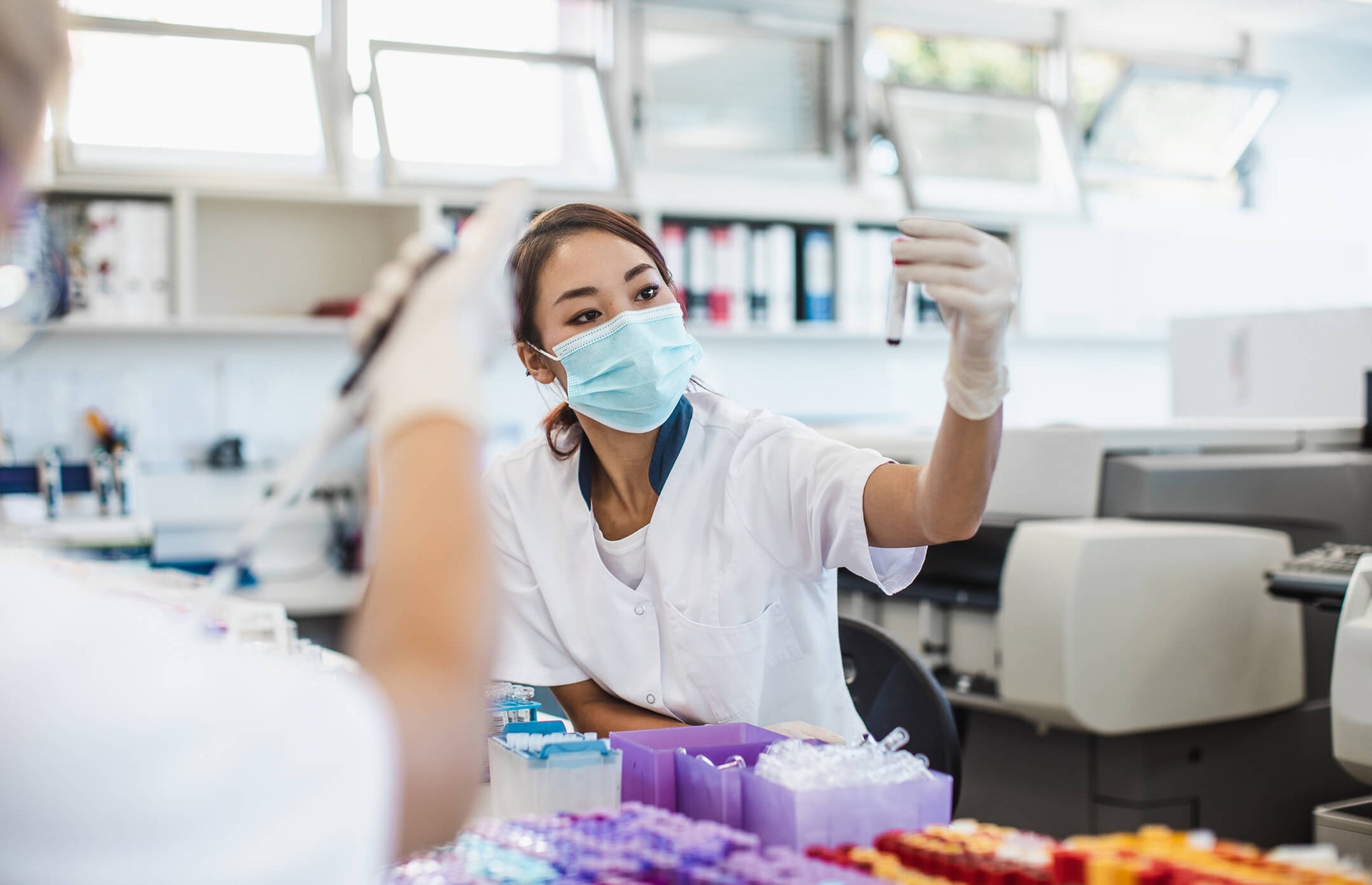 Woman looking at a test tube in a lab