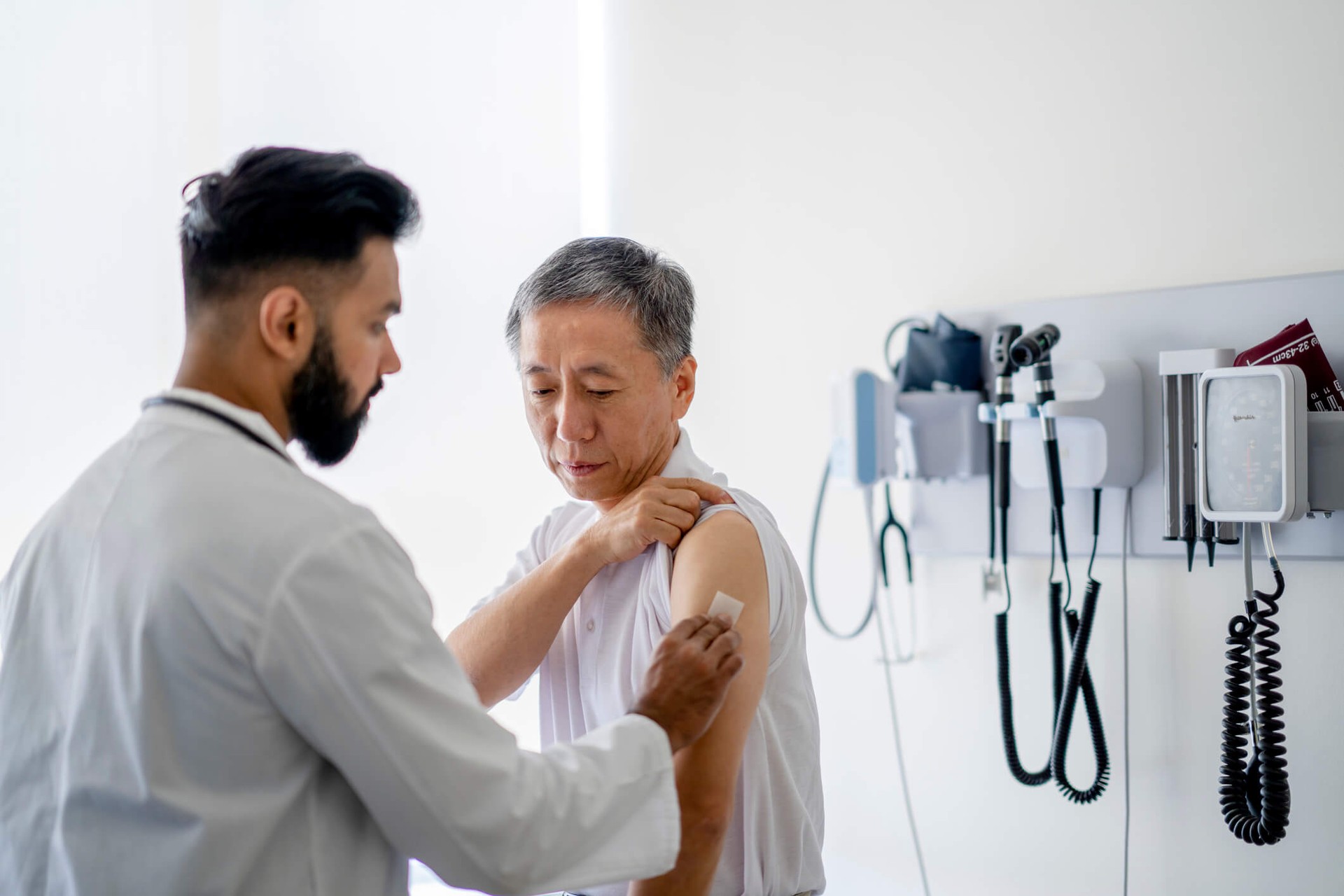 Doctor treating elderly patient