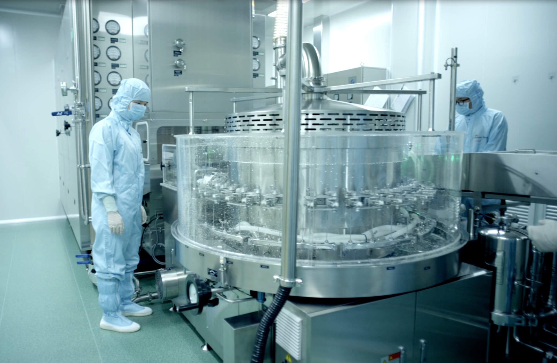 Medical worker standing near large silver tank