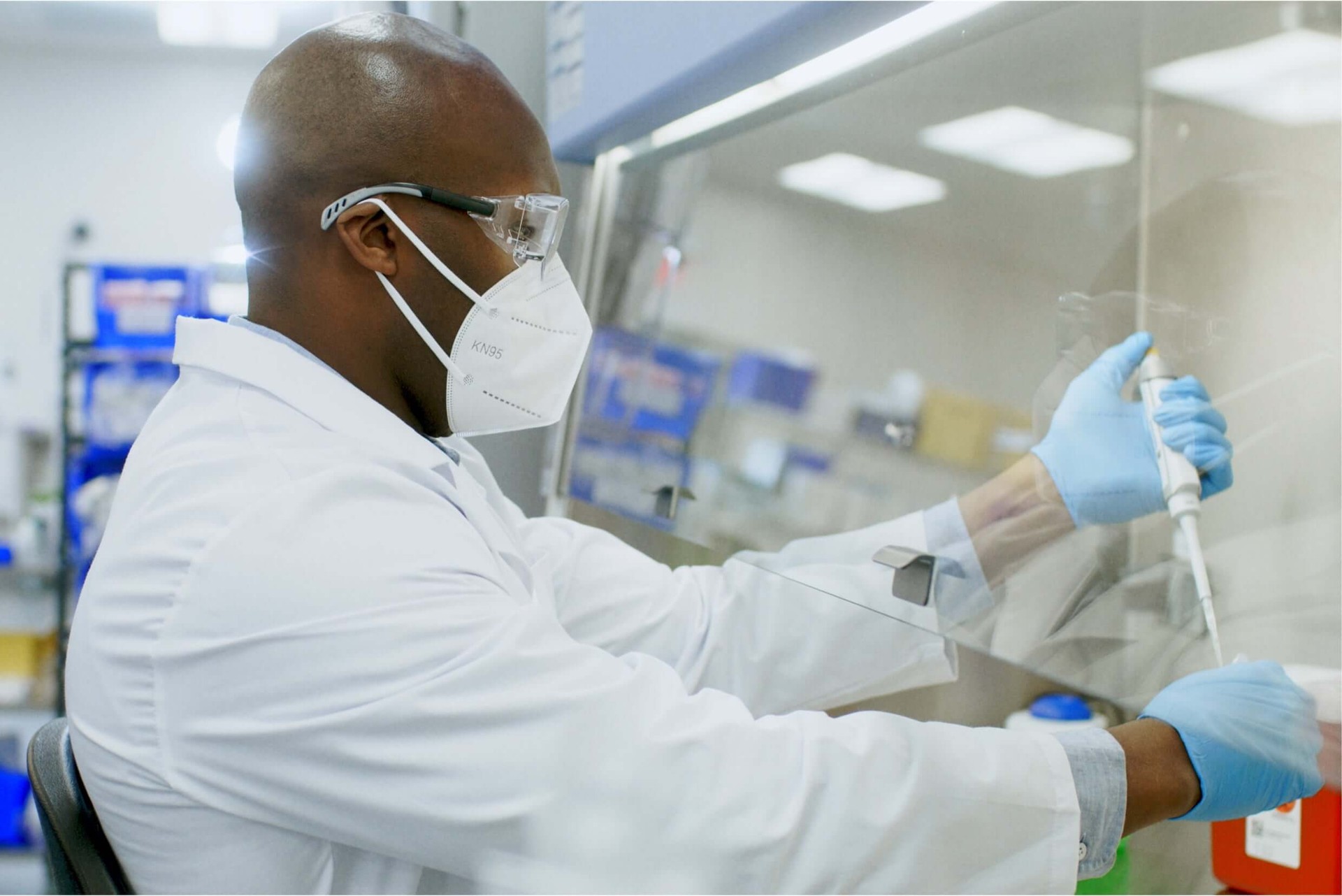 Man in mask working in medical research setting