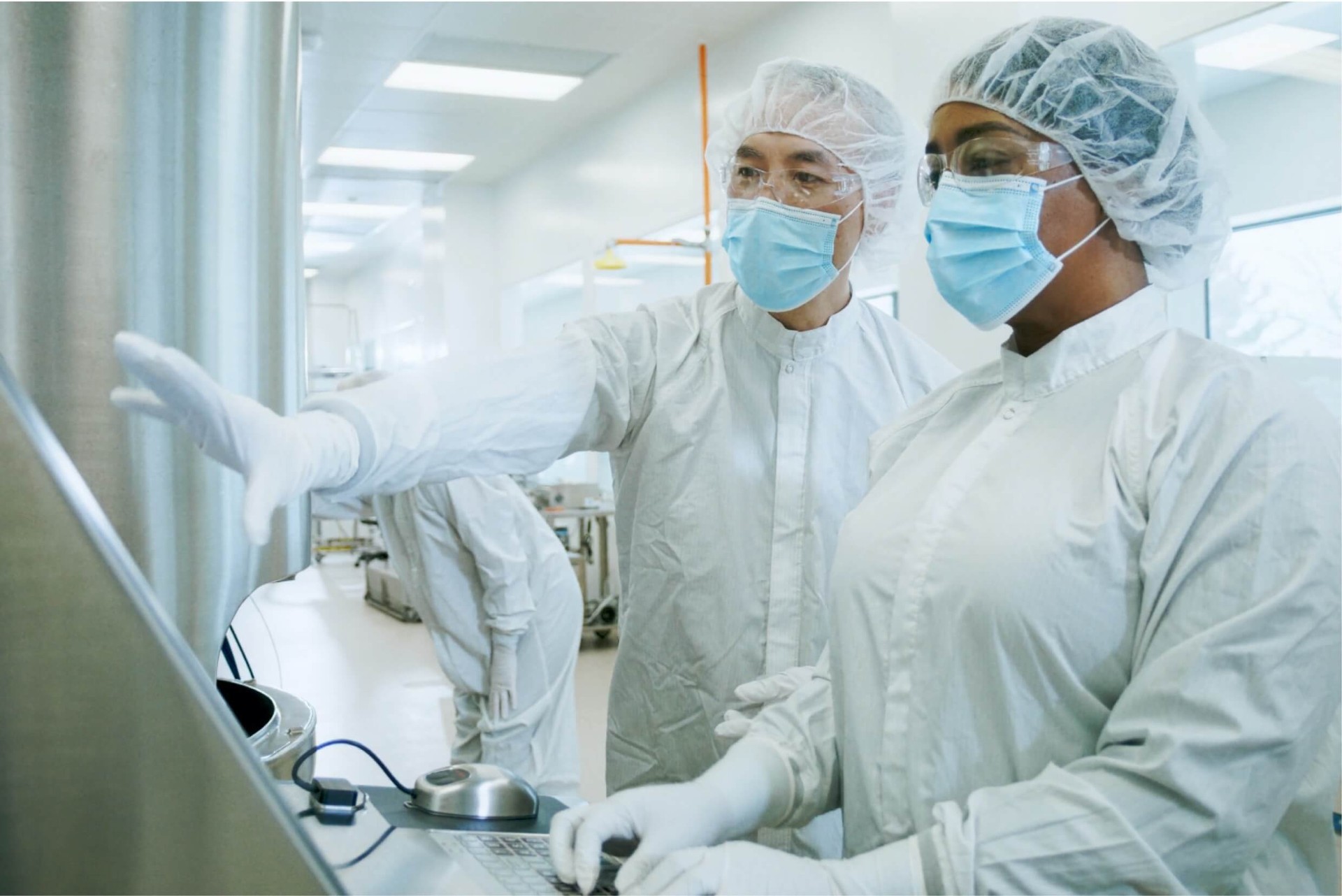 Medical research workers looking at something on a computer