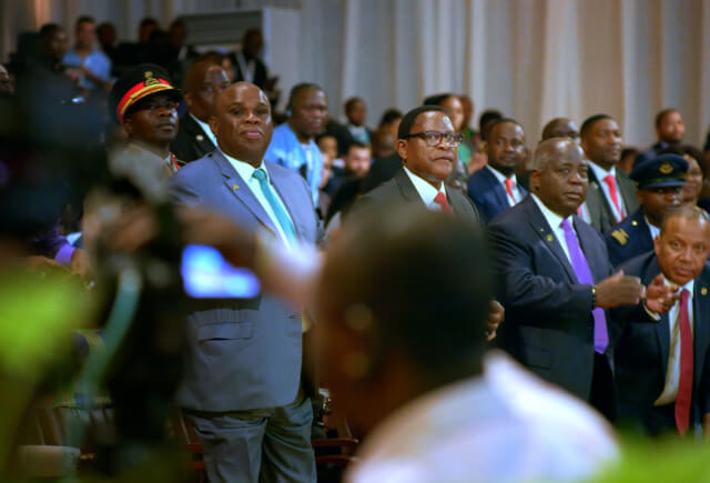 Men standing in a conference