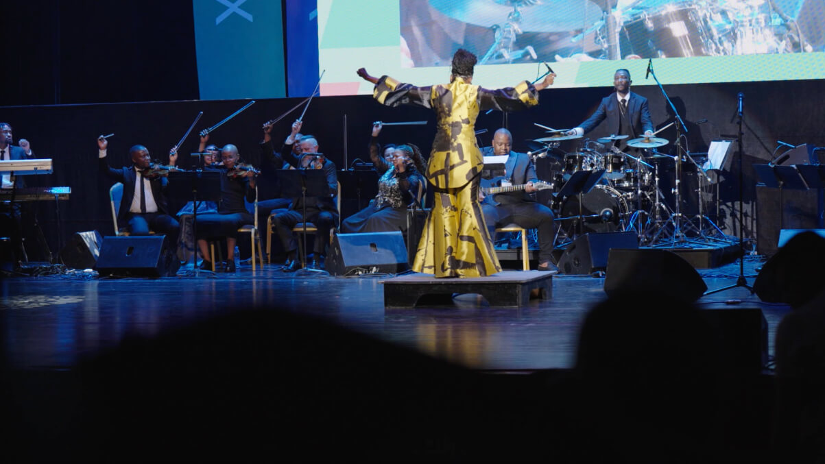 Musicians on stage with conductor