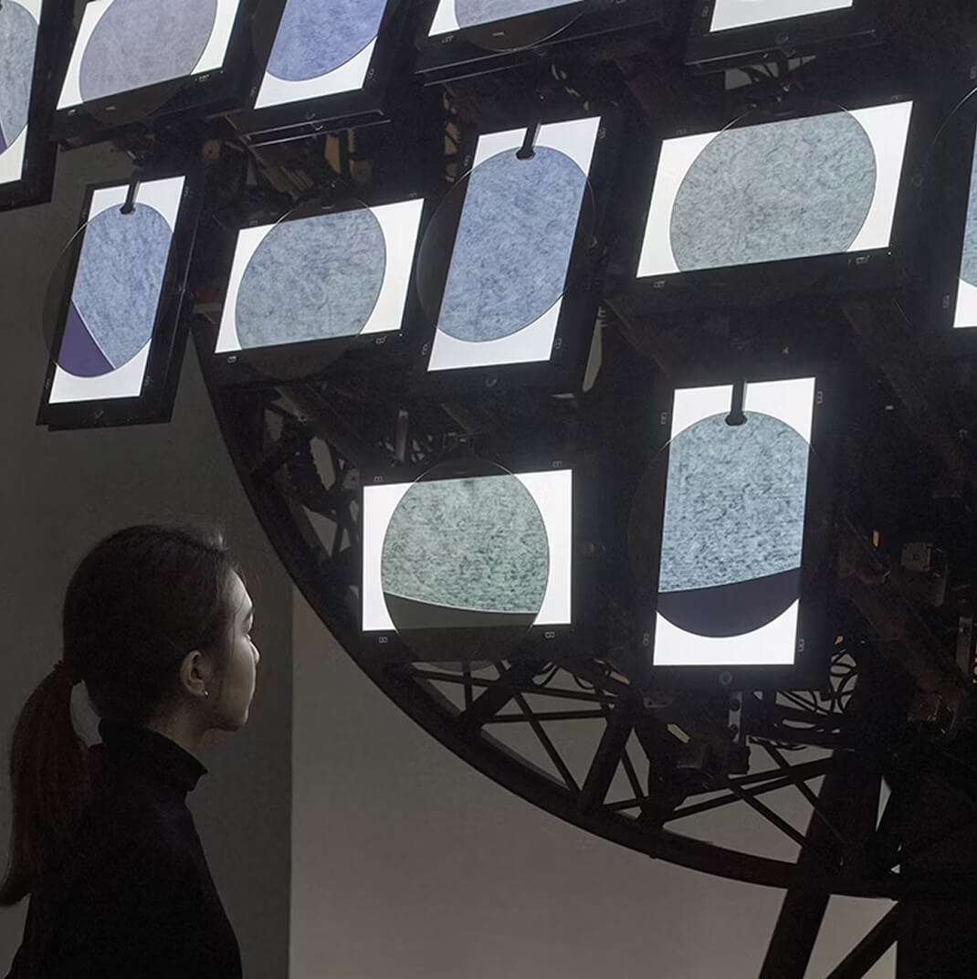 Back of a lady in front of an installation